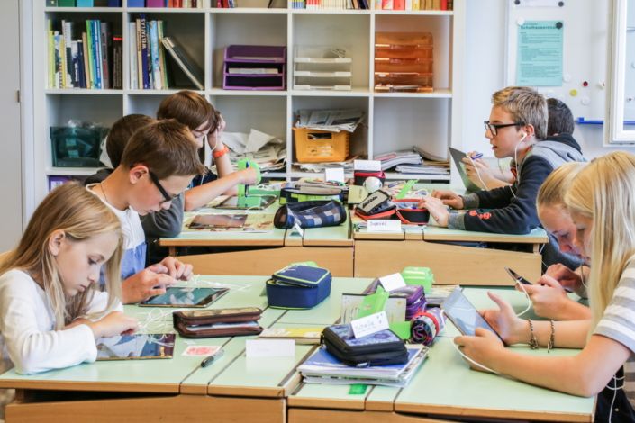 Swiss Elementary School Students Using Tablets In A Modern Classroom.